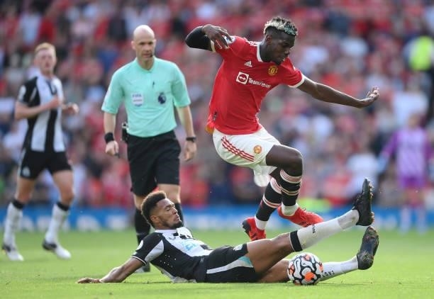 Paul Pogba of Manchester United battle for possession with Joelinton of Newcastle United during the Premier League match between Manchester United...