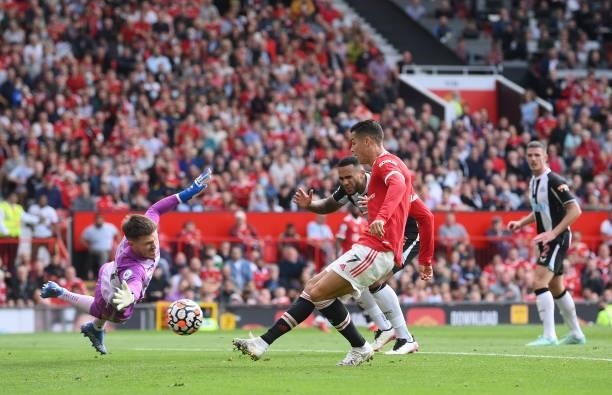 Cristiano Ronaldo of Manchester United scores his sides first goal past Freddie Woodman of Newcastle United during the Premier League match between...