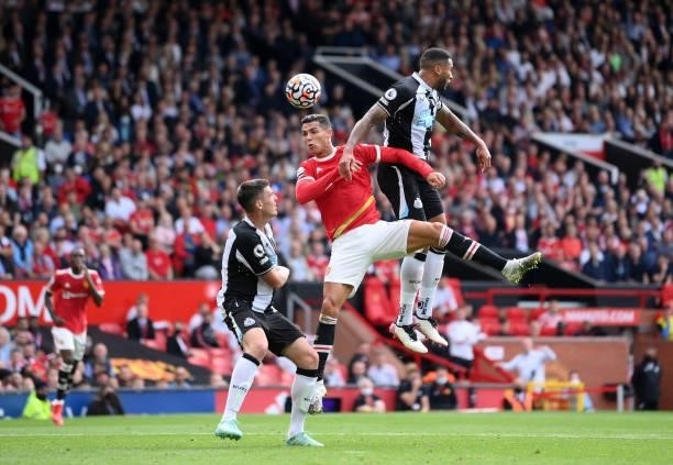 Cristiano Ronaldo of Manchester United jumps for a header with Jamaal Lascelles of Newcastle United during the Premier League match between...