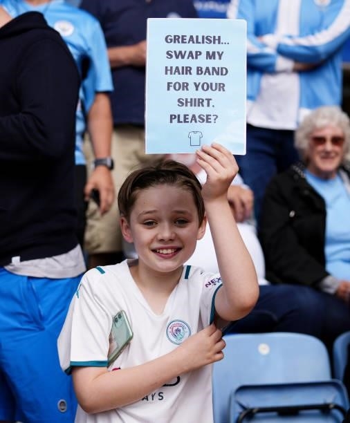 Young fan holds up a banner during the Premier League match between Leicester City and Manchester City at The King Power Stadium on September 11,...