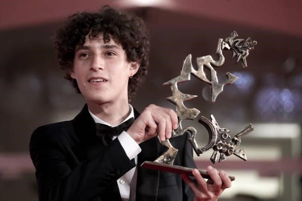 Filippo Scotti poses with Marcello Mastroianni Award for best young promising actor during the awards winner photocall of the 78th Venice...