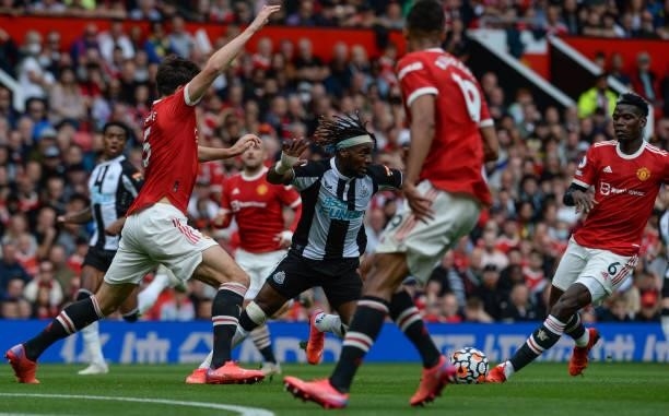Allan Saint-Maximin of Newcastle United FC is surrounded by Manchester players during the Premier League match between Manchester United and...