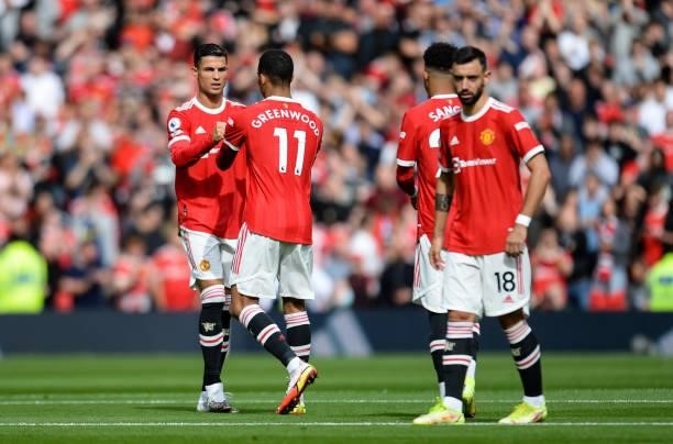 Cristiano Ronaldo of Manchester United claps fists with Mason Greenwood of Manchester United during the Premier League match between Manchester...