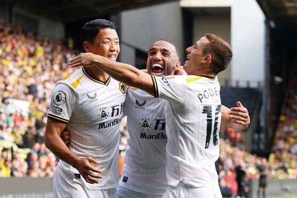 Hee-chan Hwang of Wolverhampton Wanderers celebrates after scoring his team's second goal with Marcal and Daniel Podence during the Premier League...