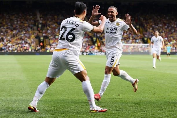 Hee-chan Hwang of Wolverhampton Wanderers celebrates after scoring his team's second goal with Marcal during the Premier League match between Watford...