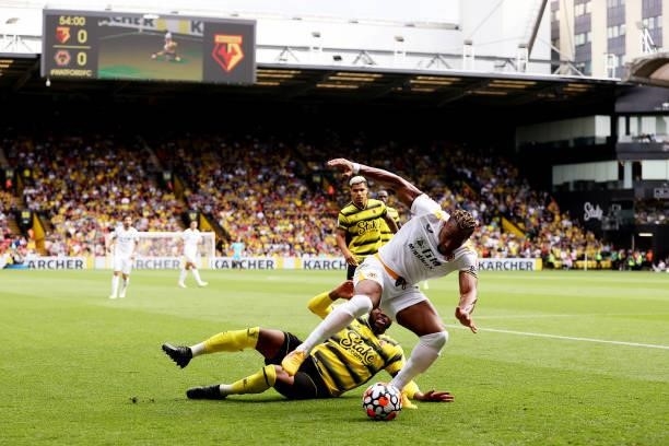 Adama Traore of Wolverhampton Wanderers is challenged by Danny Rose of Watford during the Premier League match between Watford and Wolverhampton...