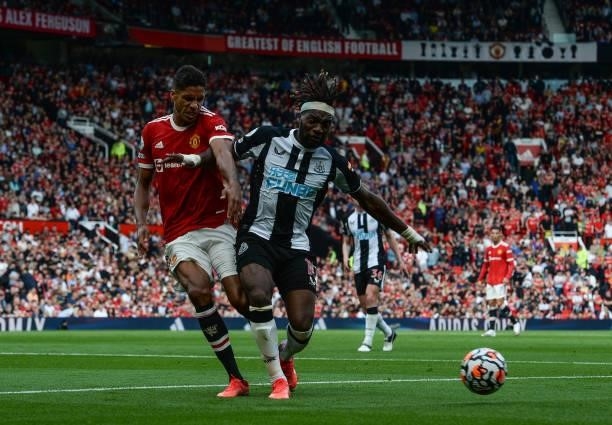 Allan Saint-Maximin of Newcastle United FC and Raphael Varane of Manchester United jostle for the ball during the Premier League match between...