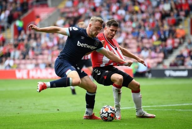 Jarrod Bowen of West Ham United battles with Romain Perraud of Southampton during the Premier League match between Southampton and West Ham United at...