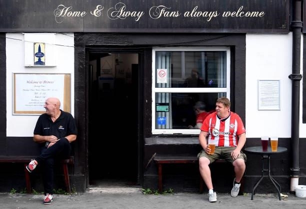 Fan sits outside a pub prior to the Premier League match between Southampton and West Ham United at St Mary's Stadium on September 11, 2021 in...