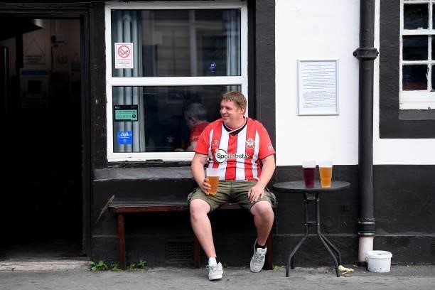 Fan sits outside a pub prior to the Premier League match between Southampton and West Ham United at St Mary's Stadium on September 11, 2021 in...