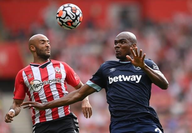 Nathan Redmond of Southampton battles for possession with Angelo Ogbonna of West Ham United during the Premier League match between Southampton and...
