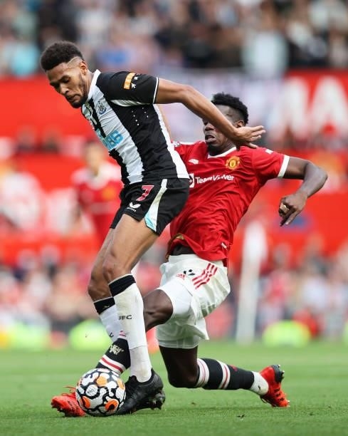 Joelinton of Newcastle United battles for possession with Paul Pogba of Manchester United during the Premier League match between Manchester United...
