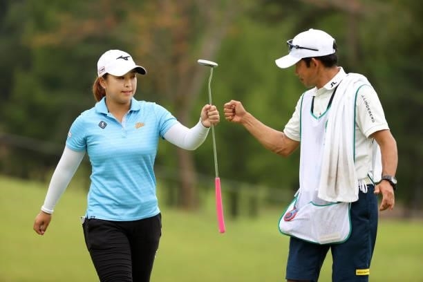 Mao Saigo of Japan fist bumps with her caddie after the birdie on the 9th green during the final round of the JLPGA Championship Konica Minolta Cup...