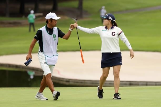 Minami Katsu of Japan fist bumps with her caddie after the birdie on the 14th green during the final round of the JLPGA Championship Konica Minolta...