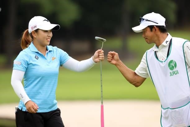 Mao Saigo of Japan fist bumps with her caddie after the birdie on the 14th green during the final round of the JLPGA Championship Konica Minolta Cup...
