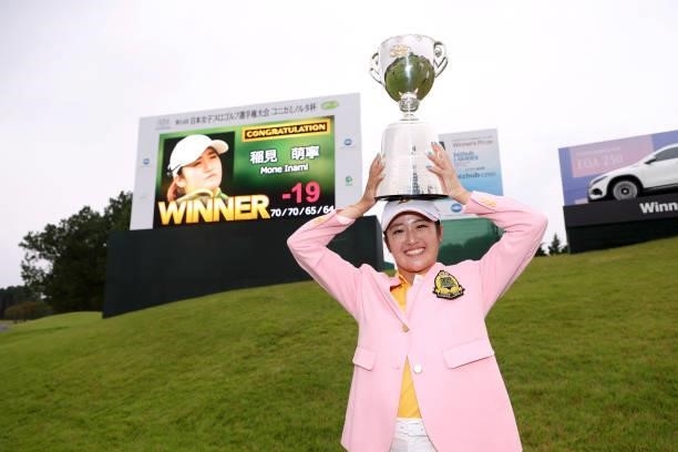 Mone Inami of Japan poses with the trophy after winning the tournament following the final round of the JLPGA Championship Konica Minolta Cup at...