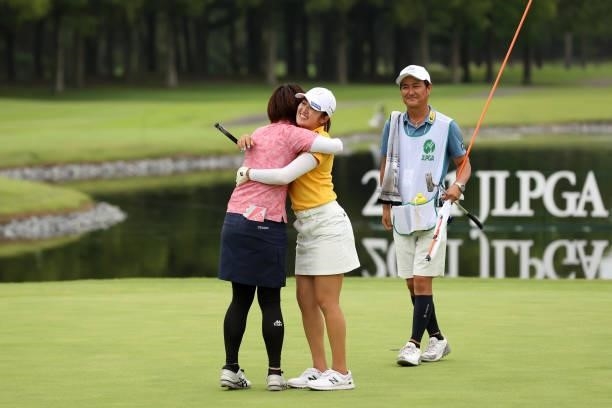 Mone Inami of Japan is congratulated by Shiho Oyama after winning the tournament on the 18th green during the final round of the JLPGA Championship...