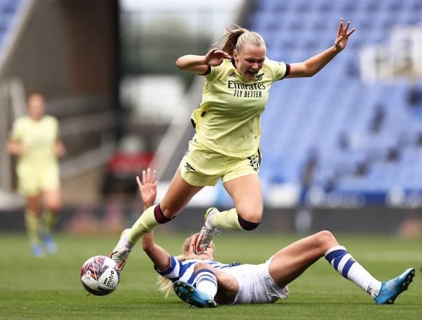 Frida Maanum of Arsenal is challenged by Justine Vanhaevermaet of Reading during the Barclays FA Women's Super League match between Reading Women and...