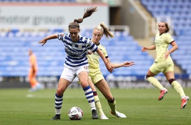 Emma Harries of Reading is challenged by Leah Williamson of Arsenal during the Barclays FA Women's Super League match between Reading Women and...