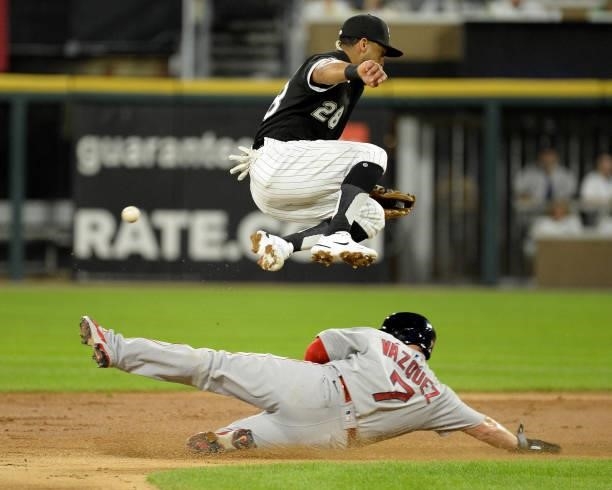 Cesar Hernandez of the Chicago White Sox cannot catch the throw from Yasmani Grandal as Christian Vazquez of Boston Red Sox reaches second base...