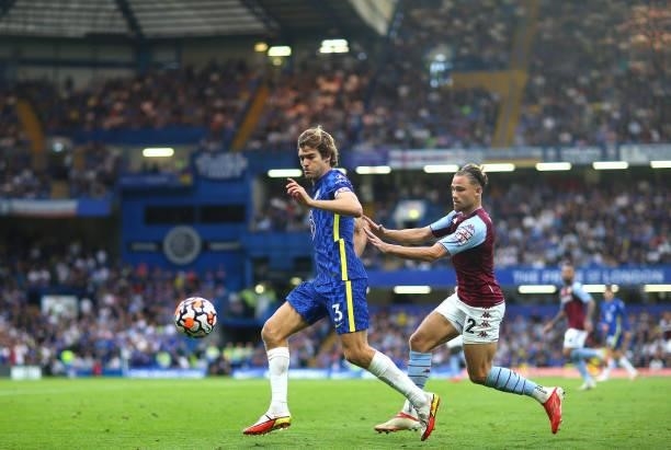 Marcos Alonso of Chelsea FC and Matthew Cash of Aston Villa chase the ball during the Premier League match between Chelsea and Aston Villa at...