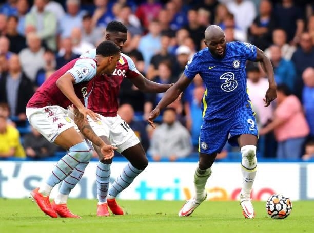 Romelu Lukaku of Chelsea FC controls the ball under pressure of Ezri Konza and Axel Tuanzebe of Aston Villa during the Premier League match between...