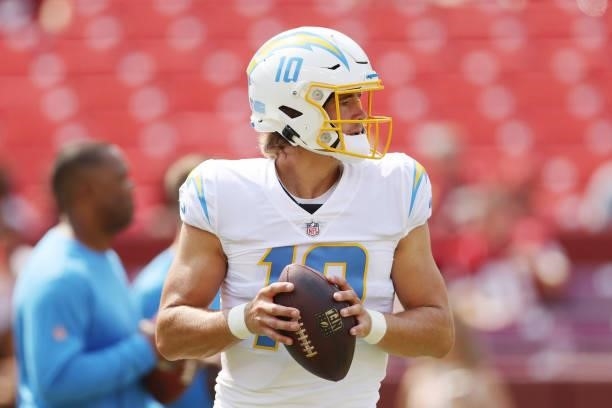 Justin Herbert of the Los Angeles Chargers warms up prior to the game against the Washington Football Team at FedExField on September 12, 2021 in...