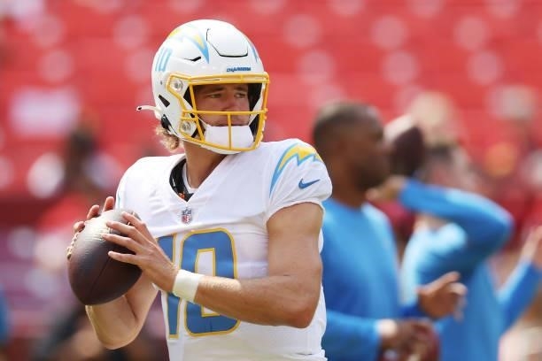 Justin Herbert of the Los Angeles Chargers warms up prior to the game against the Washington Football Team at FedExField on September 12, 2021 in...
