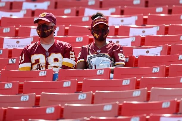 Washington Football Team fans look on while wearing masks prior to the game against the Los Angeles Chargers at FedExField on September 12, 2021 in...