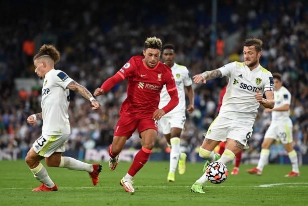 Alex Oxlade-Chamberlain of Liverpool battles for possession with Liam Cooper of Leeds United during the Premier League match between Leeds United and...