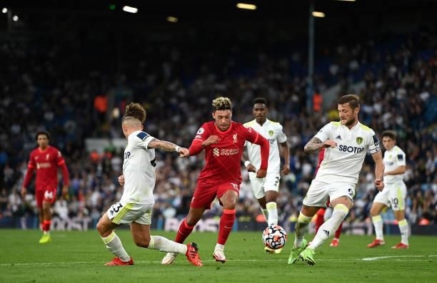 Alex Oxlade-Chamberlain of Liverpool battles for possession with Kalvin Phillips and Liam Cooper of Leeds United during the Premier League match...