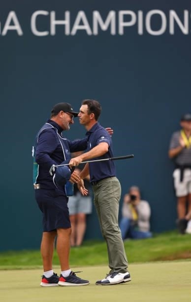 Billy Horschel of the United States of America hugs caddie Mark ‘Fooch’ Fulcher after finishing their round on the 18th green during Day Four of The...