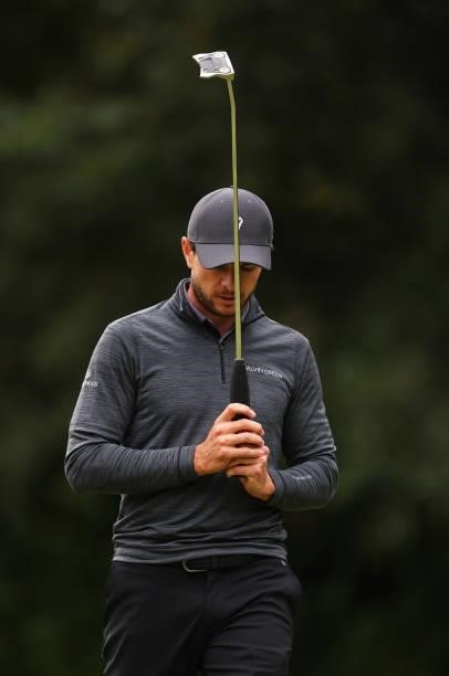 Laurie Canter of England reacts missing a birdie putt on the 16th green during Day Four of The BMW PGA Championship at Wentworth Golf Club on...