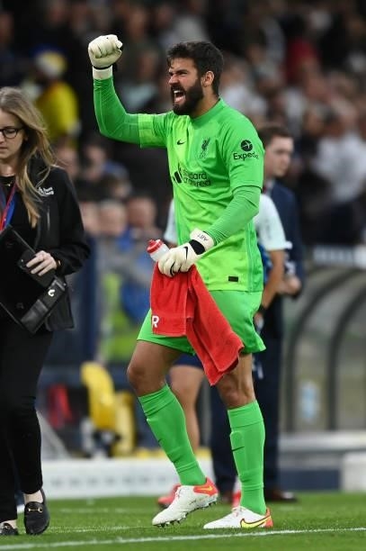 Alisson Becker of Liverpool celebrates their side's victory after the Premier League match between Leeds United and Liverpool at Elland Road on...