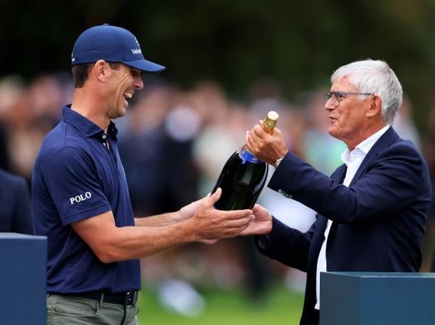 Billy Horschel of the United States of America is presented with a jeroboam of champagne during Day Four of The BMW PGA Championship at Wentworth...