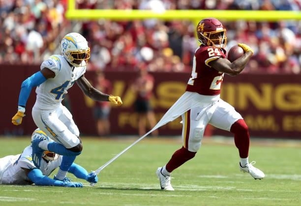 Antonio Gibson of the Washington Football Team runs with the ball against the Los Angeles Chargers during the first quarter at FedExField on...