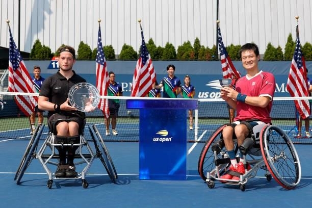 Alfie Hewett of Great Britain holds the runner-up trophy alongside Shingo Kunieda of Japan who celebrates with the championship trophy their...
