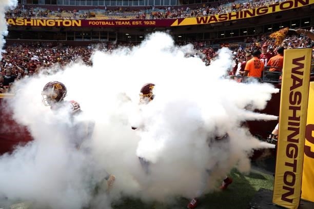 The Washington Football Team take the field prior to the game against the Los Angeles Chargers at FedExField on September 12, 2021 in Landover,...