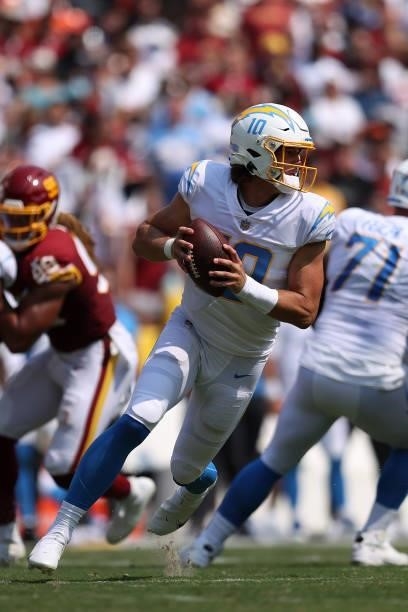 Justin Herbert of the Los Angeles Chargers looks to pass against the Washington Football Team during the first half at FedExField on September 12,...