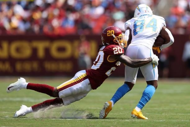 Bobby McCain of the Washington Football Team tackles K.J. Hill of the Los Angeles Chargers during the first quarter at FedExField on September 12,...