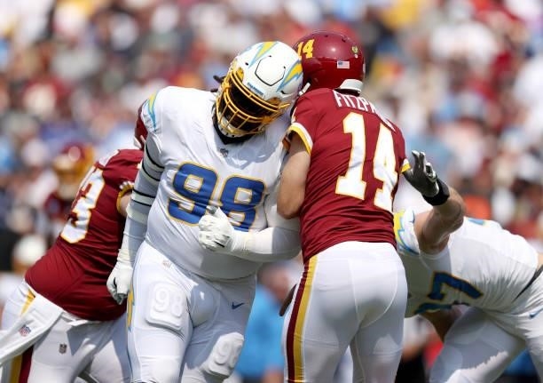 Linval Joseph of the Los Angeles Chargers hits Ryan Fitzpatrick of the Washington Football Team during the first half at FedExField on September 12,...