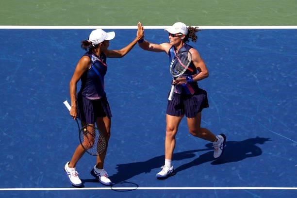 Samantha Stosur of Australia and Shuai Zhang of China celebrate winning the first set against Coco Gauff of the United States and Catherine McNally...