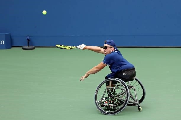 Dylan Alcott of Australia returns the ball against Niels Vink of the Netherlands during their Wheelchair Quad Singles final match on Day Fourteen of...