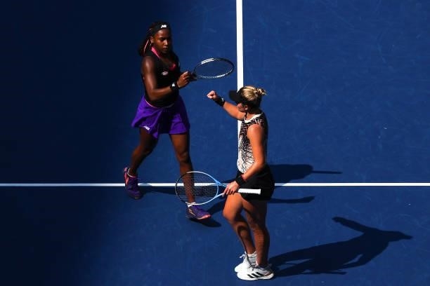 Coco Gauff of the United States and Catherine McNally of the United States react as the play against Samantha Stosur of Australia and Shuai Zhang of...