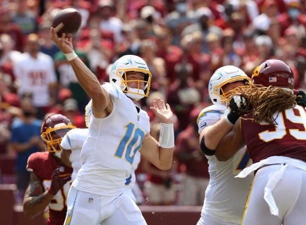 Justin Herbert of the Los Angeles Chargers throws a pass against the Washington Football Team during the first half at FedExField on September 12,...