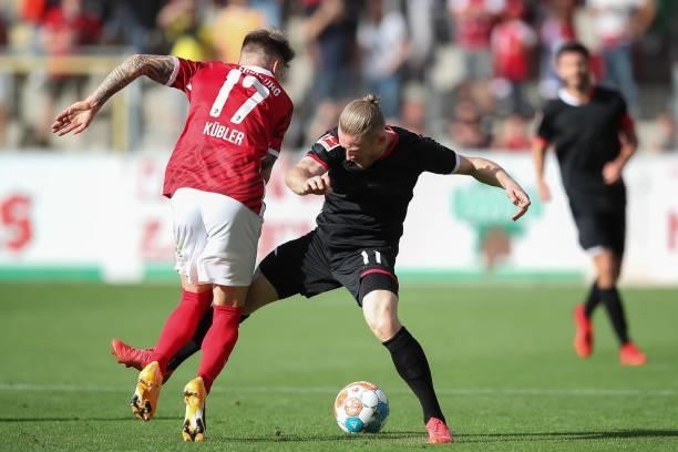 Lukas Kuebler of SC Freiburg is tackled by Florian Kainz of 1.FC Koeln during the Bundesliga match between Sport-Club Freiburg and 1. FC Köln at...