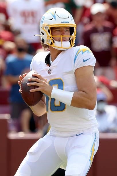 Justin Herbert of the Los Angeles Chargers looks to pass against the Washington Football Team during the second quarter at FedExField on September...