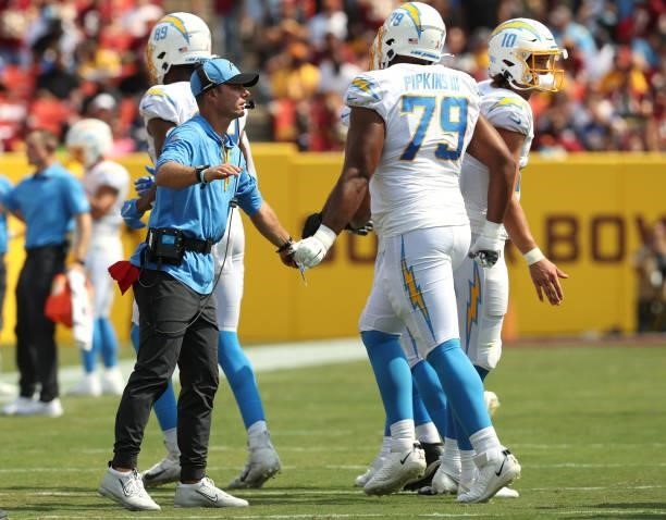 Head coach Brandon Staley of the Los Angeles Chargers high fives Trey Pipkins during the first half against the Washington Football Team at...