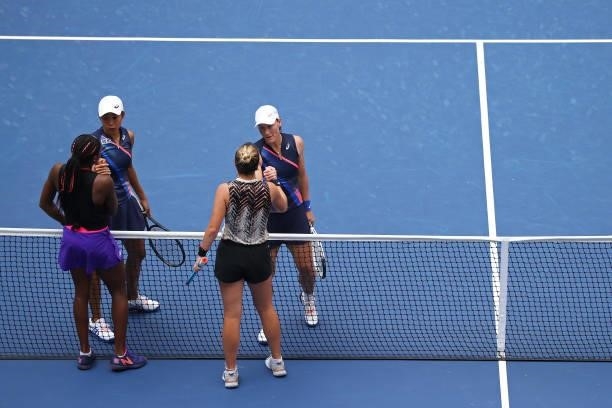 Samantha Stosur of Australia and Shuai Zhang of China shake hands with Coco Gauff of the United States and Catherine McNally of the United States...