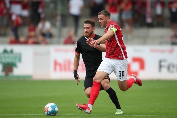 Christian Guenter of SC Freiburg challenges Salih Oezcan of 1.FC Koeln during the Bundesliga match between Sport-Club Freiburg and 1. FC Köln at...